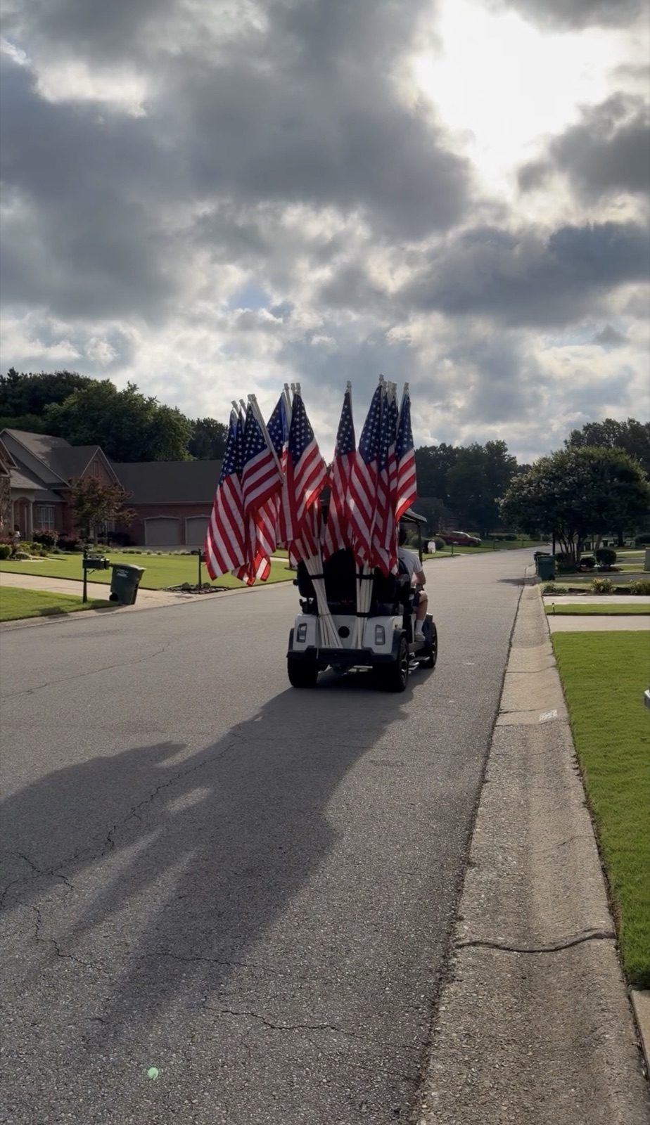 Flags loaded on a cart heading out on the installation route